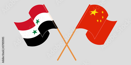 Crossed and waving flags of Syria and China
