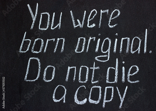 
Motivational lettering on chalkboard you were born original, don't die a copy