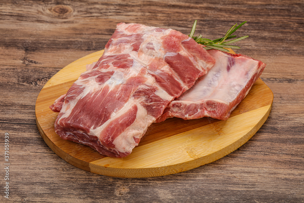 Raw pork ribs served rosemary