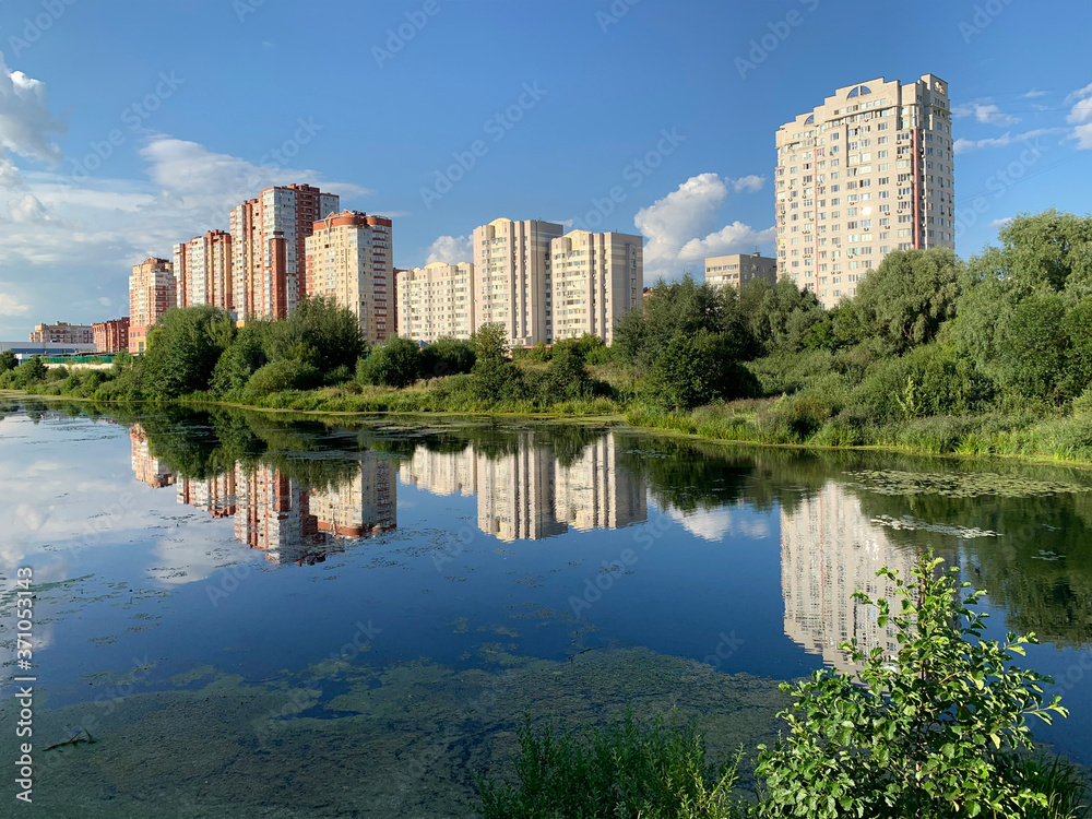 Russia, Moscow region, the city of Balashikha. Pekhorka river in summer sunny day and  view of Zarechnaya street