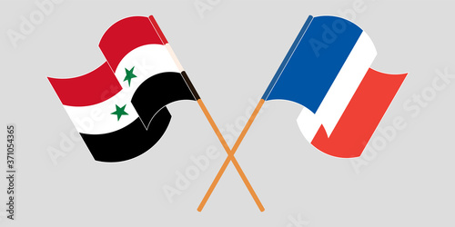 Crossed and waving flags of Syria and France