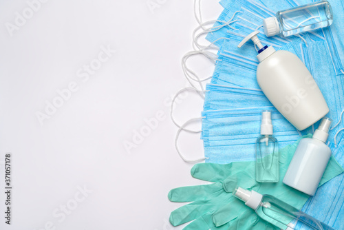 flat layout of hygiene items - latex gloves, mask and hand sanitizer or liquid soap isolated on white background with clipping parh photo