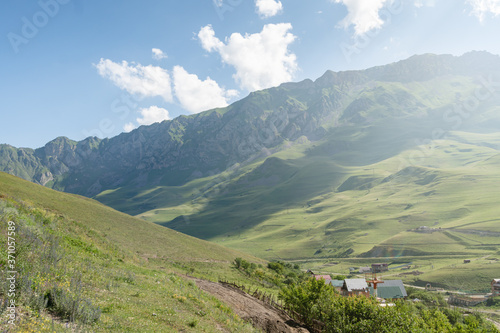 View of highest mountain village in mountains with cloudy sky.