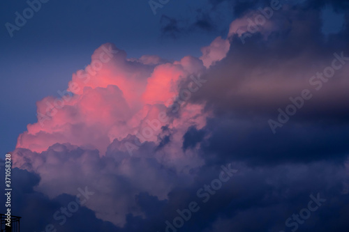 Sky with rose and dark clouds.Heavenly dreamy fluffy colorful fantasy clouds.