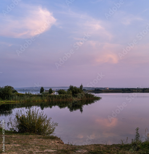 Fototapeta Naklejka Na Ścianę i Meble -  Evening dusk on summer valley lake. Natural seasonal, weather, countryside beauty concept and background scene.