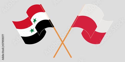 Crossed and waving flags of Syria and Poland
