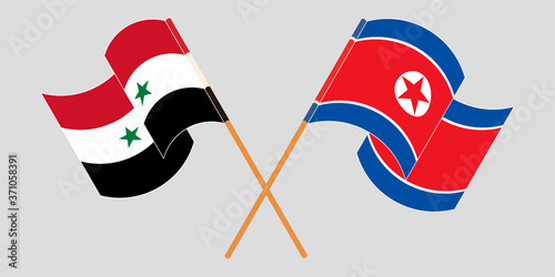 Crossed and waving flags of Syria and North Korea