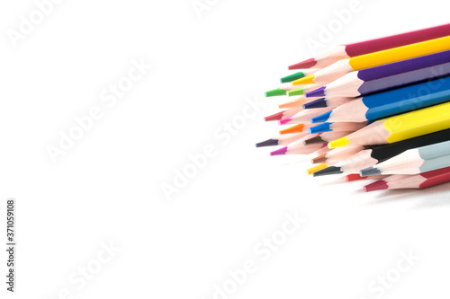 Colored sharpened pencils on a white background. Copy space, selective focus.