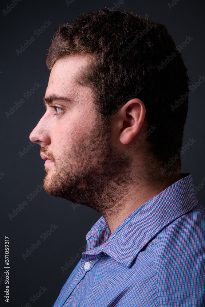 Portrait of young handsome overweight bearded businessman Portrait of young handsome overweight bearded businessman