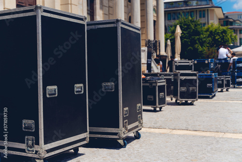 Boxes stage equipment for a concert on wood and old brick