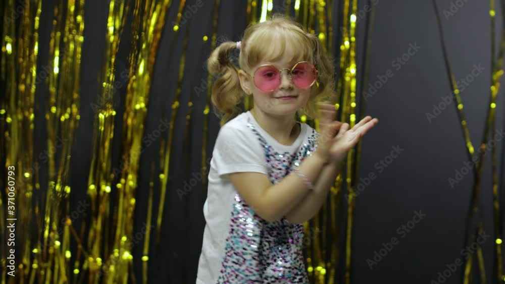 Stylish child dancing, make faces, shaking shoulders in silly dance ...