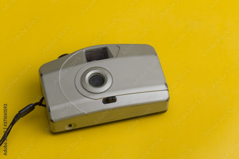 old cream color camera with yellow background