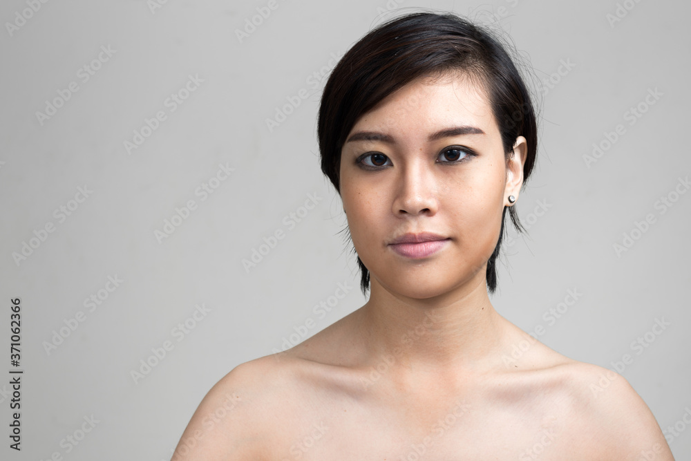 Portrait of young beautiful Asian woman with short hair shirtless Portrait of young beautiful Asian woman with short hair shirtless