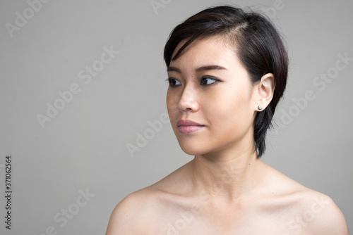 Portrait of young beautiful Asian woman with short hair shirtless