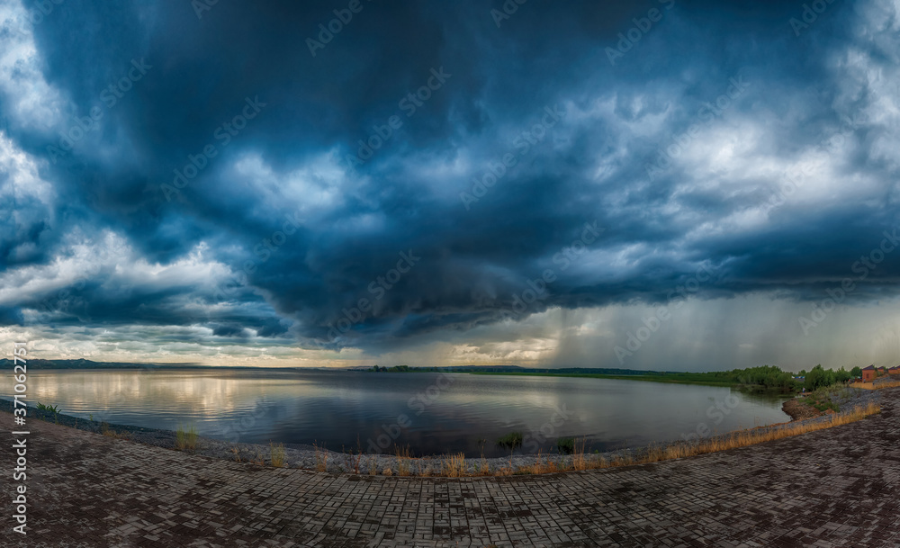 storm over the lake. dark rainy clouds storm over the lake. dark rainy clouds