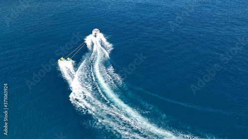 Aerial drone photo of extreme powerboat donut water-sports cruising in high speed in deep blue open ocean bay © aerial-drone