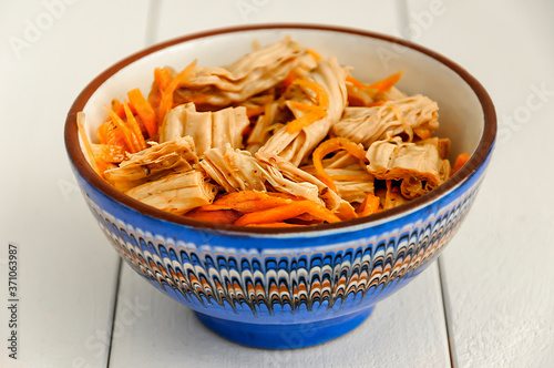 Spicy Chinese or Korean Yuba (tofu bamboo) and carrots salad. Food product made from soybeans. Selective focus.