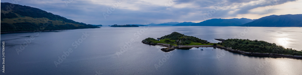 Aerial view of the sound of shuna and shuna island on the west coast of the argyll region of the highlands of Scotland during a summer storm showing a salmon fish farm
