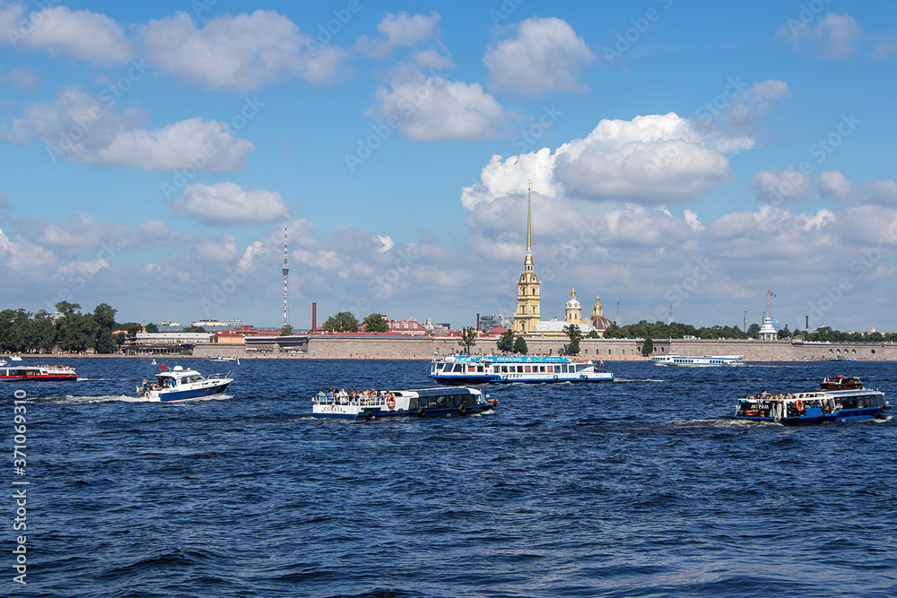 Saint Petersburg,Russia, July 8, 2020, Peter and Paul fortress. In the photo, Peter and Paul fortress and boats with tourists, view from the Palace embankment