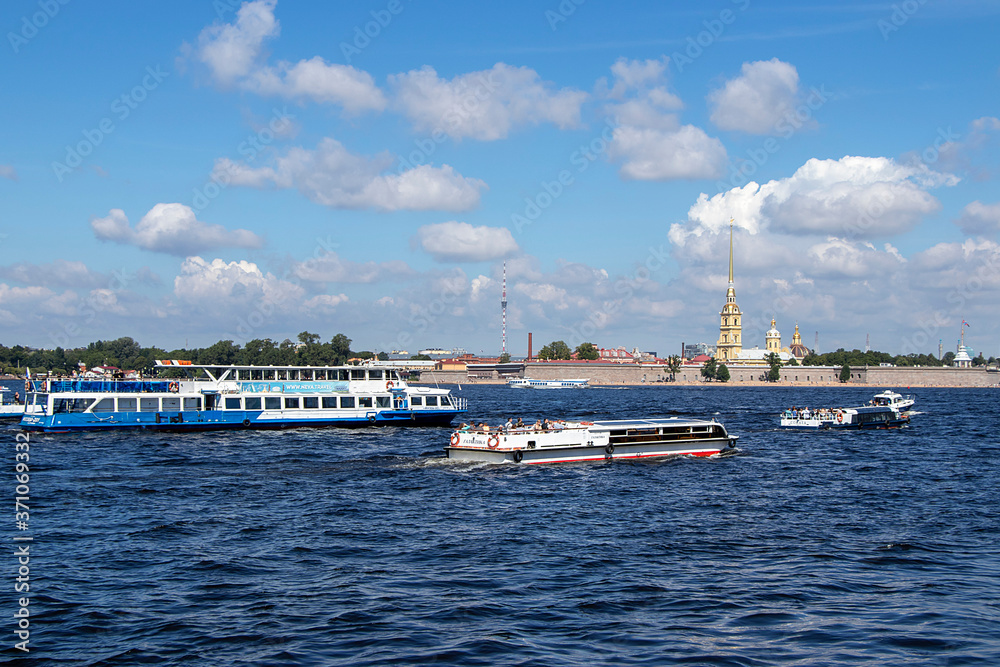 Saint Petersburg,Russia, July 8, 2020, Peter and Paul fortress. In the photo, Peter and Paul fortress and boats with tourists, view from the Palace embankment