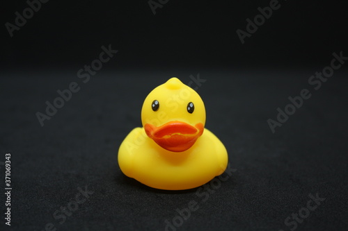 yellow rubber duck on black background