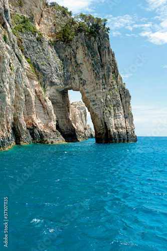 Beautiful view on Blue Caves rock arches cascade in blue water of Ionian Sea Inside Blue cave.