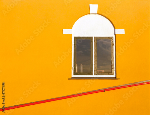 Yellow wall with red pole