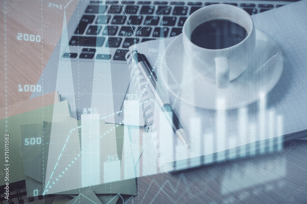 Double exposure of forex chart drawing and desktop with coffee and items on table background. Concept of financial market trading Double exposure of forex chart drawing and desktop with coffee and items on table background. Concept of financial market trading