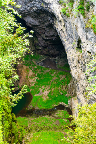 Macocha Abyss - large limestone gorge in Moravian Karst, Czech: Moravsky Kras, Czech Republic. View from the top - lower lookput platform