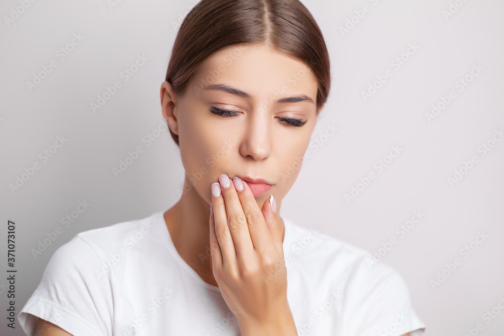 Tooth problems, an attractive woman is experiencing a painful toothache.
