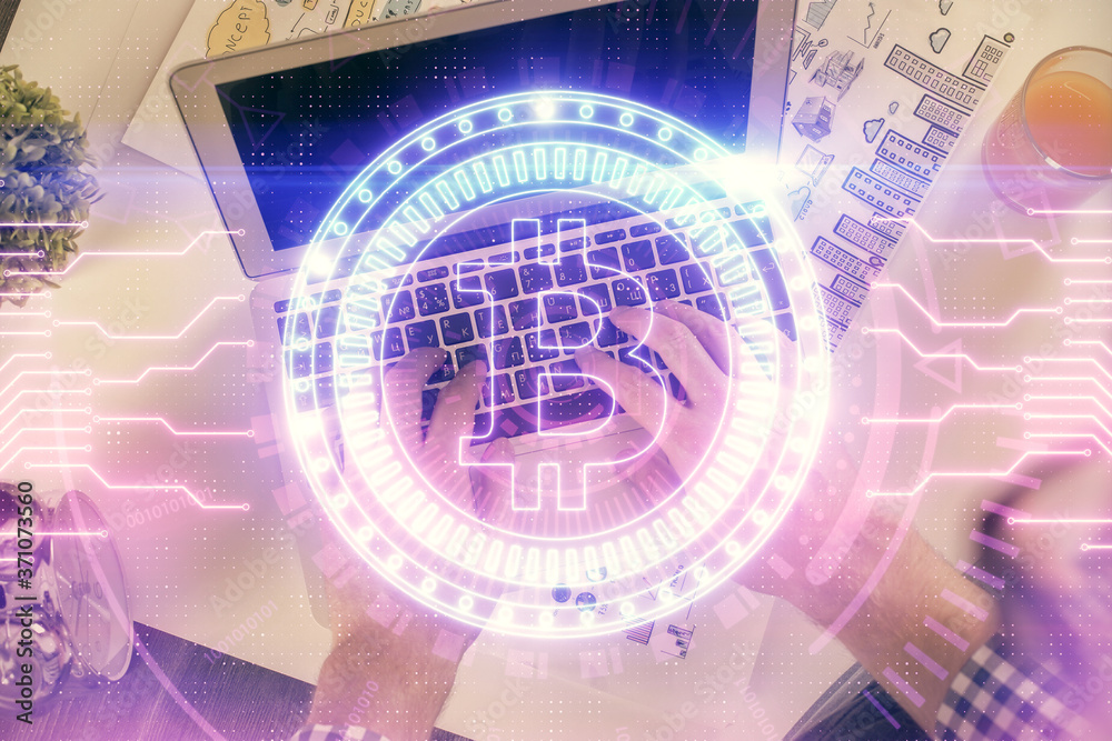 Double exposure of man's hands typing over computer keyboard and crypto currency theme hologram drawing. Top view. Blockchain concept. Double exposure of man's hands typing over computer keyboard and crypto currency theme hologram drawing. Top view. Blockchain concept.