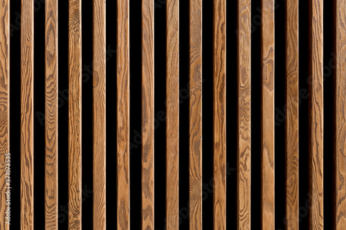 Texture of wood lath wall background. Seamless pattern of modern wall paneling with vertical wooden slats for background
