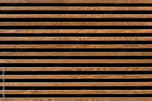Texture of wood lath wall background. Seamless pattern of modern wall paneling with horizontal wooden slats for background