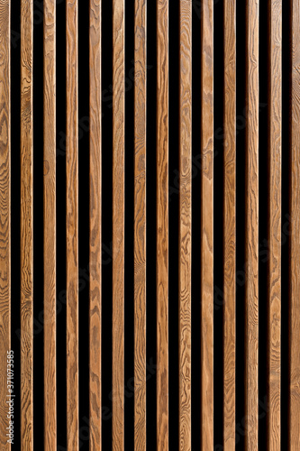 Texture of wood lath wall background. Seamless pattern of modern wall paneling with vertical wooden slats for background