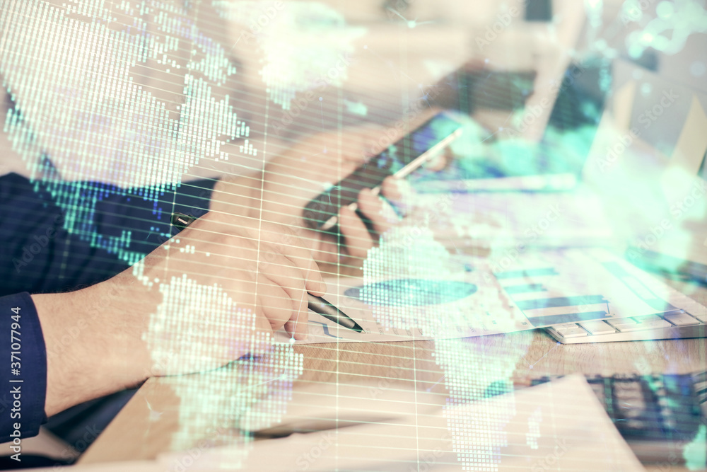 Double exposure of man's hands holding and using a phone and international business theme drawing. Double exposure of man's hands holding and using a phone and international business theme drawing.