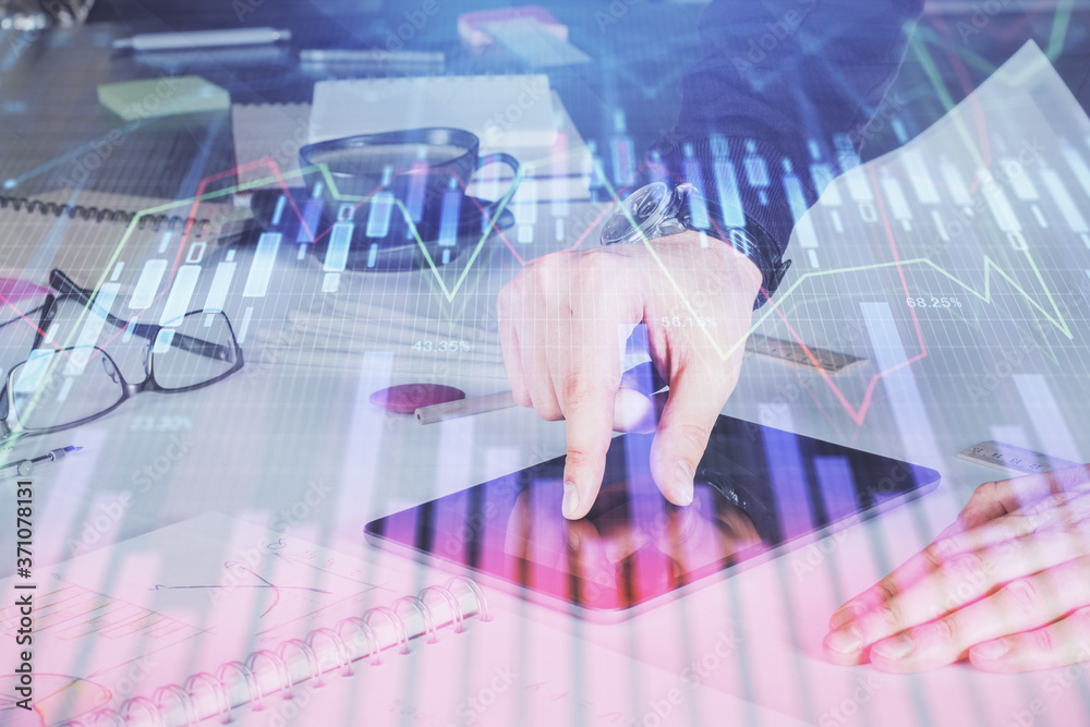 Double exposure of man's hands holding and using a digital device and forex graph drawing. Financial market concept. Double exposure of man's hands holding and using a digital device and forex graph drawing. Financial market concept.