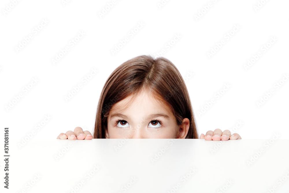 Cute little child girl looking up on the desk at school. Cute little child girl looking up on the desk at school.