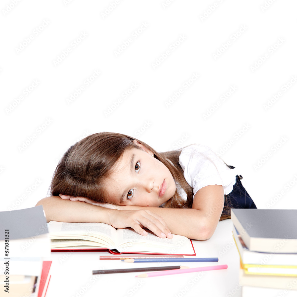 Tired little child girl sleeping on the desk at school. Tired little child girl sleeping on the desk at school.