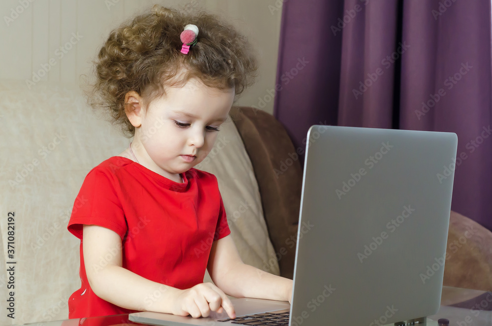 home, leisure, games, online learning, technology and internet concept - little girl with laptop at home. copy space, place for text. home, leisure, games, online learning, technology and internet concept - little girl with laptop at home. copy space, place for text.