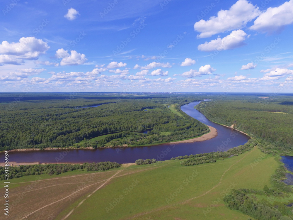 Bends of the river and blue sky with clouds. Sysola river, Komi Republic, Russia.