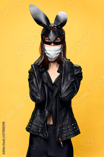  Female rabbit mask posing sexually in a medical mask from coronavirus