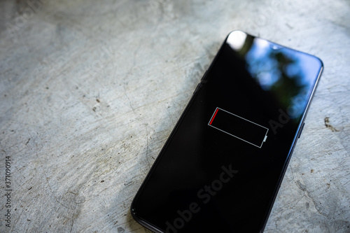 close-up view of smartphone with low battery on screen.