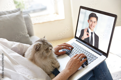 asian business people meeting online via video call using laptop computer