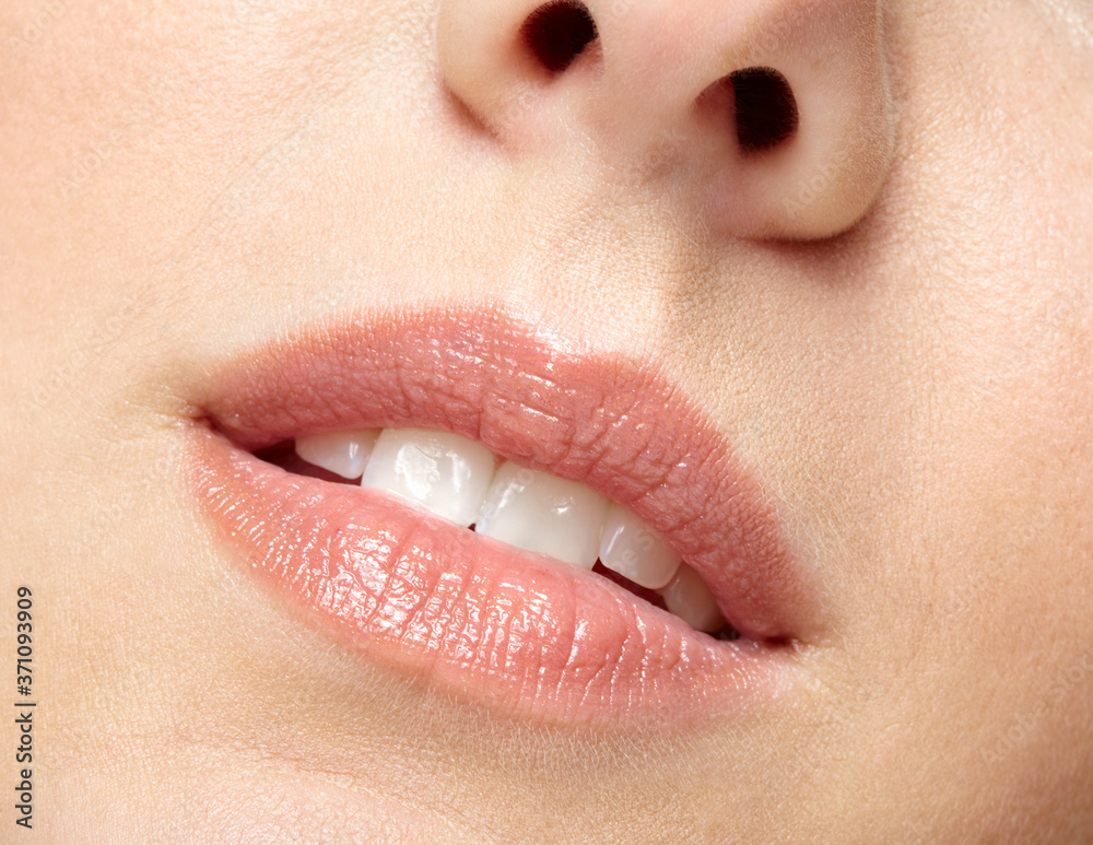 Naklejka premium Closeup macro portrait of female part of face. Human woman lips with day beauty makeup
