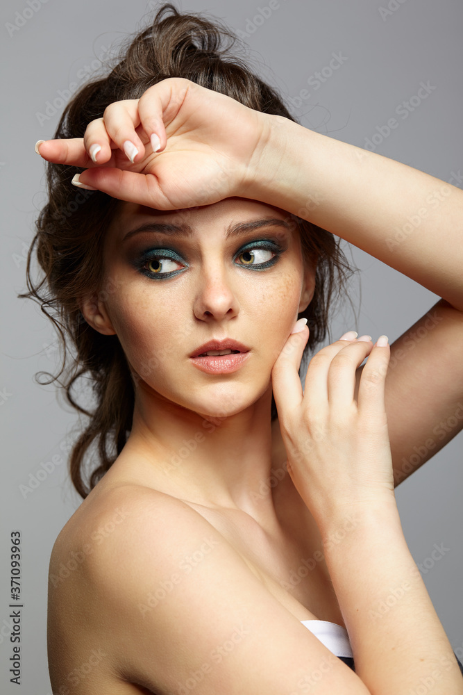 Obraz premium Beauty portrait of young woman. Brunette girl with long hair and day female makeup