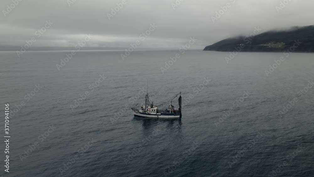 Fishermen On The Trawler Fishing Boat And Floating On The Calm Sea On A Foggy Day In Quebec, Canada. - aerial drone Fishermen On The Trawler Fishing Boat And Floating On The Calm Sea On A Foggy Day In Quebec, Canada. - aerial drone