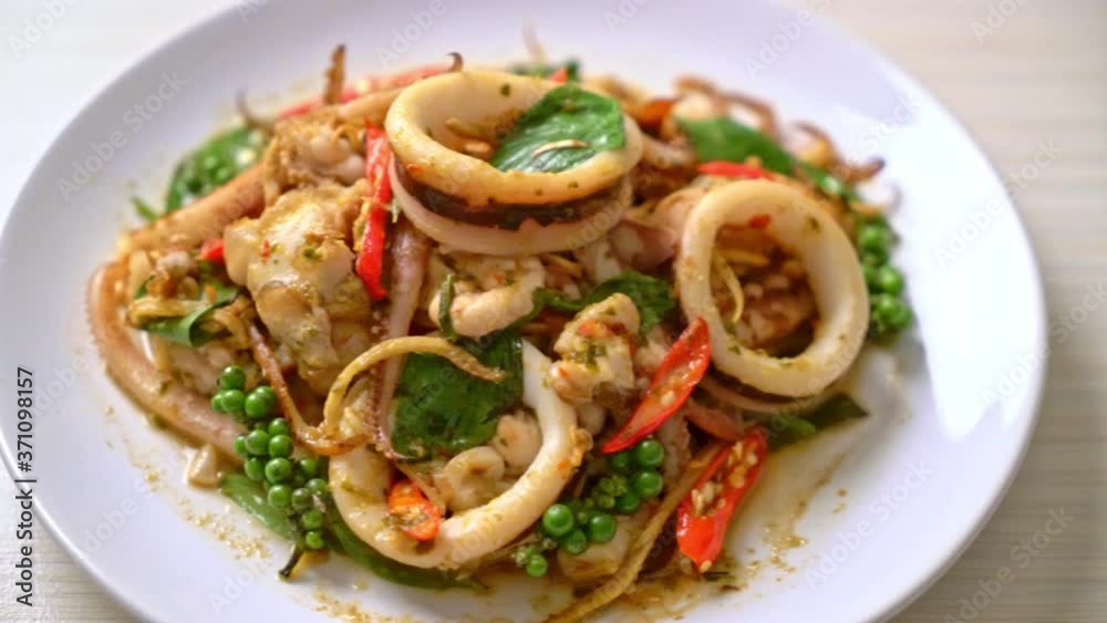 stir fried holy basil with octopus or squid and herb - Asian food style stir fried holy basil with octopus or squid and herb - Asian food style