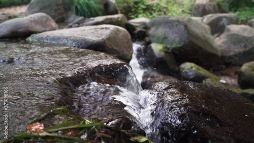 Water flowing in slow motion over rock garden in China photo