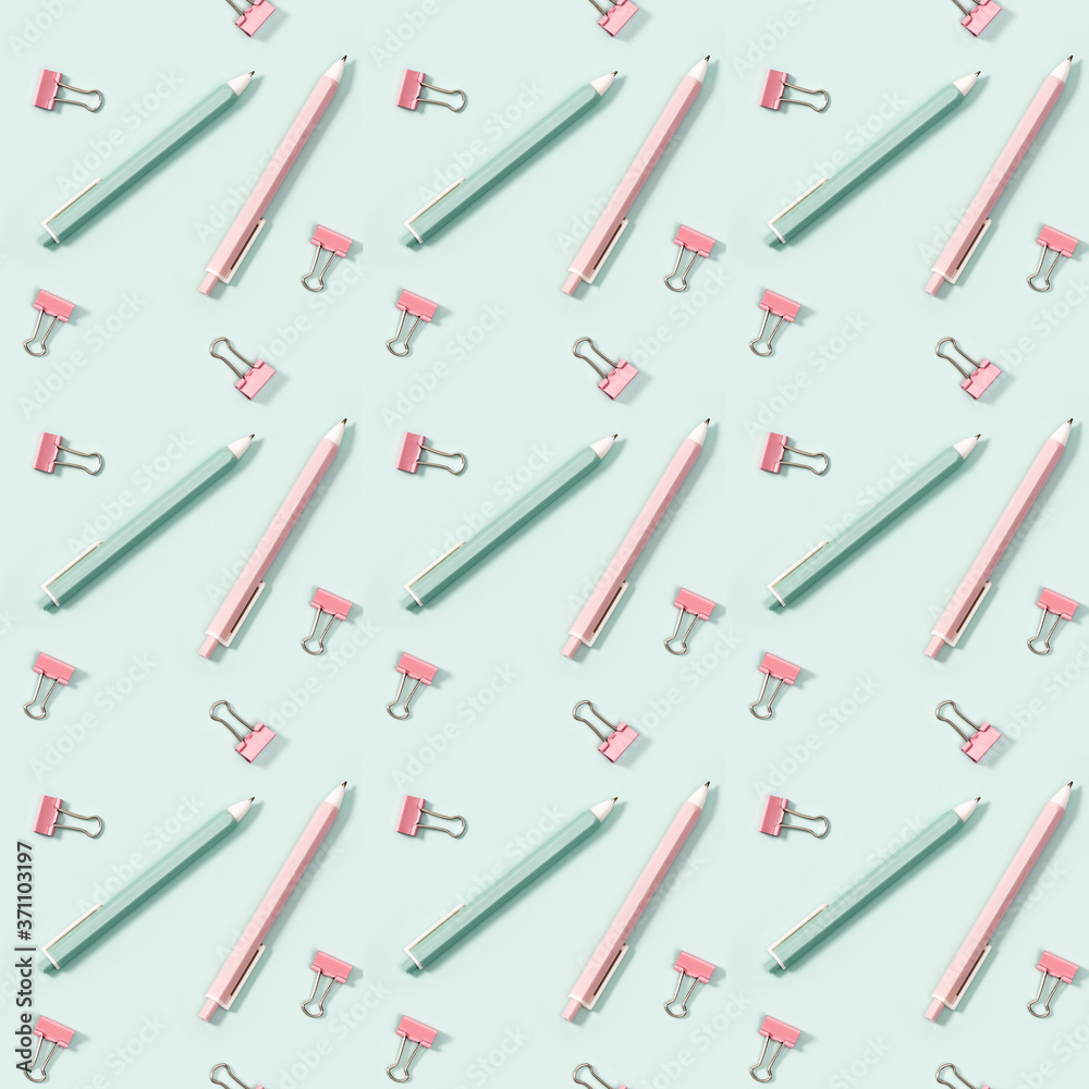 Creative seamless pattern with office supplies, pink and green colored pens and metal paper clips. Creative seamless pattern with office supplies, pink and green colored pens and metal paper clips.