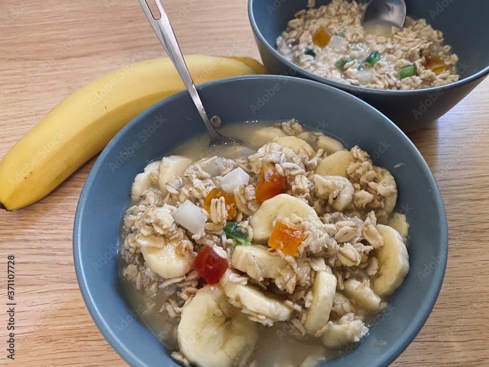 The oatmeal with fruits and banana on the table The oatmeal with fruits and banana on the table
